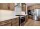 Modern kitchen featuring stainless steel appliances and wood cabinets at 20311 W Montecito Ave, Buckeye, AZ 85396