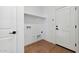 Bright laundry room features sleek shelving, wood-look tile flooring, and modern fixtures at 20311 W Montecito Ave, Buckeye, AZ 85396