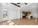 Open-concept living room with wood-style floors leading into the kitchen at 20311 W Montecito Ave, Buckeye, AZ 85396