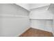 A walk-in closet features organized shelving and wood-look tile flooring at 20311 W Montecito Ave, Buckeye, AZ 85396