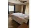 Basic bedroom featuring a bed with floral bedding, ceiling fan, and a closet for storage at 3330 E Main St # 440, Mesa, AZ 85213