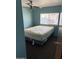 Simple bedroom with a full-size bed, ceiling fan and a window that provides natural light at 3330 E Main St # 440, Mesa, AZ 85213