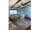 Comfortable living room with beamed ceiling, ceiling fan, a neutral sofa, and a patterned rug at 3330 E Main St # 440, Mesa, AZ 85213
