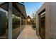 Modern exterior with glass walls and wooden walkway at 9556 E Celestial Dr, Scottsdale, AZ 85262