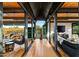 Long hallway with wood floors and views of the desert landscape at 9556 E Celestial Dr, Scottsdale, AZ 85262