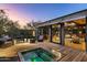 Deck with hot tub, fire pit, and comfortable seating area at 9556 E Celestial Dr, Scottsdale, AZ 85262
