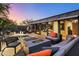 Modern patio with seating area, fire pit, and hot tub at 9556 E Celestial Dr, Scottsdale, AZ 85262