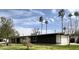 A modern home boasts a well-manicured lawn, palm trees, and a spacious garage at 895 W Tyson St, Chandler, AZ 85225