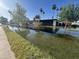 The house sits in floodwaters with its reflection in the clear water, under a clear sky at 895 W Tyson St, Chandler, AZ 85225