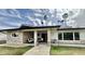 Charming single-story home with stone accents, a covered porch, and lush lawn at 895 W Tyson St, Chandler, AZ 85225