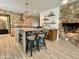 Open concept kitchen with stone fireplace and island seating at 895 W Tyson St, Chandler, AZ 85225