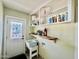 Bright laundry room features ample shelving and storage, with a utility sink and door with stained glass at 895 W Tyson St, Chandler, AZ 85225
