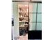 Organized pantry behind sliding frosted glass door, providing ample space for storing kitchen essentials at 895 W Tyson St, Chandler, AZ 85225