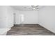 Open and airy living room with wood floors and neutral walls, offering a versatile space at 24606 W St Catherine Ave, Buckeye, AZ 85326