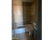 Bathroom featuring a toilet, tub, and partial tiling at 5559 N 62Nd Ave, Glendale, AZ 85301