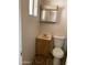 Bathroom features a toilet, sink, and medicine cabinet at 5559 N 62Nd Ave, Glendale, AZ 85301