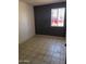 Modest bedroom with window and tile floor at 5559 N 62Nd Ave, Glendale, AZ 85301