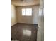 Bedroom featuring tile flooring, textured walls, and a window at 5559 N 62Nd Ave, Glendale, AZ 85301