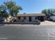 Modest single-story home with a mature tree in the front yard and a covered carport at 5559 N 62Nd Ave, Glendale, AZ 85301