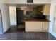 Open concept kitchen with breakfast bar, tile floor and ample cabinet space at 5559 N 62Nd Ave, Glendale, AZ 85301