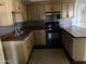 Functional kitchen with older appliances and wood cabinets at 5559 N 62Nd Ave, Glendale, AZ 85301