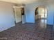 Open living room with tiled floors and an arched doorway at 5559 N 62Nd Ave, Glendale, AZ 85301
