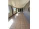 Living room with neutral tile flooring and brick wall accents at 5559 N 62Nd Ave, Glendale, AZ 85301