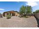 Large backyard with gravel and a mature tree at 42459 W Paseo Dr, Maricopa, AZ 85138