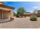 Spacious backyard with gravel and a mature tree at 42459 W Paseo Dr, Maricopa, AZ 85138