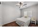 Bright bedroom with a queen-size bed, ceiling fan, and window blinds at 42459 W Paseo Dr, Maricopa, AZ 85138