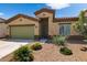 Well-maintained house with green garage door and desert landscaping at 42459 W Paseo Dr, Maricopa, AZ 85138
