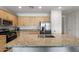 Modern kitchen with granite countertops and stainless steel appliances at 42459 W Paseo Dr, Maricopa, AZ 85138