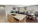 Open concept kitchen with island and granite countertops at 42459 W Paseo Dr, Maricopa, AZ 85138