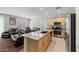 Open concept kitchen with island and granite countertops at 42459 W Paseo Dr, Maricopa, AZ 85138