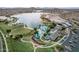 Aerial view of community amenities, a lake, and the surrounding residential area provides a picturesque landscape at 15175 S 185Th Ave, Goodyear, AZ 85338