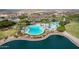 Stunning aerial view of community pool with lake and palm trees offering resort-style living at 15175 S 185Th Ave, Goodyear, AZ 85338