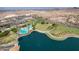 Remarkable aerial view of the lake, park, and recreation area with palm trees in a Primary-planned community at 15175 S 185Th Ave, Goodyear, AZ 85338