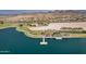 Expansive aerial view of the lake, park, and recreation area featuring a walking path and desert landscape at 15175 S 185Th Ave, Goodyear, AZ 85338