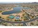 An aerial view of a community featuring a lake, recreation areas, and palm-lined streets near residences at 15175 S 185Th Ave, Goodyear, AZ 85338