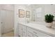Bright bathroom with double vanity, framed art, and tiled floors at 15175 S 185Th Ave, Goodyear, AZ 85338
