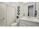 Clean bathroom features a tub with shower, toilet, vanity with sink, and decorative bird art at 15175 S 185Th Ave, Goodyear, AZ 85338