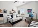Bright guest bedroom with daybed, window views, and desk workspace at 15175 S 185Th Ave, Goodyear, AZ 85338