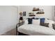 Comfortable guest bedroom with a daybed, stylish pillows, and decorative wall shelves at 15175 S 185Th Ave, Goodyear, AZ 85338