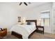 Bright bedroom featuring a king bed, two side tables with lamps, and a ceiling fan at 15175 S 185Th Ave, Goodyear, AZ 85338