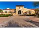 Elegant stone clubhouse entrance with manicured landscaping and a welcoming ambiance for residents at 15175 S 185Th Ave, Goodyear, AZ 85338