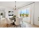 Bright dining area with pool view, features a round table, seating for six, and modern chandelier at 15175 S 185Th Ave, Goodyear, AZ 85338