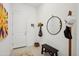 Bright entryway featuring a coat rack, round mirror, and stylish decor at 15175 S 185Th Ave, Goodyear, AZ 85338