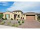 Beautiful single-Gathering home featuring a tile roof, a brick driveway, and manicured landscaping at 15175 S 185Th Ave, Goodyear, AZ 85338