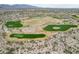 Expansive aerial shot of a community golf course offering lush greens and challenging play in a desert landscape at 15175 S 185Th Ave, Goodyear, AZ 85338