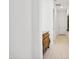 Well-lit hallway with tile flooring and a decorative dresser along the wall at 15175 S 185Th Ave, Goodyear, AZ 85338